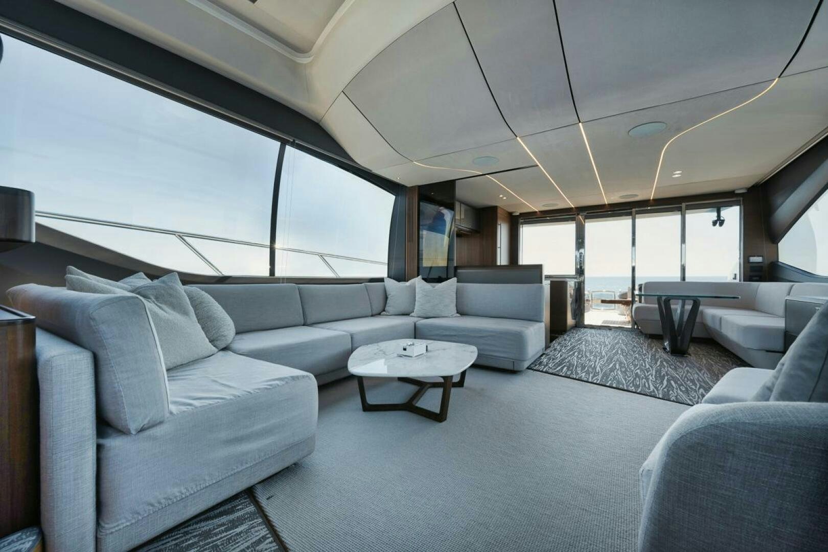 a living room with a large window aboard HOOKED HER Yacht for Sale