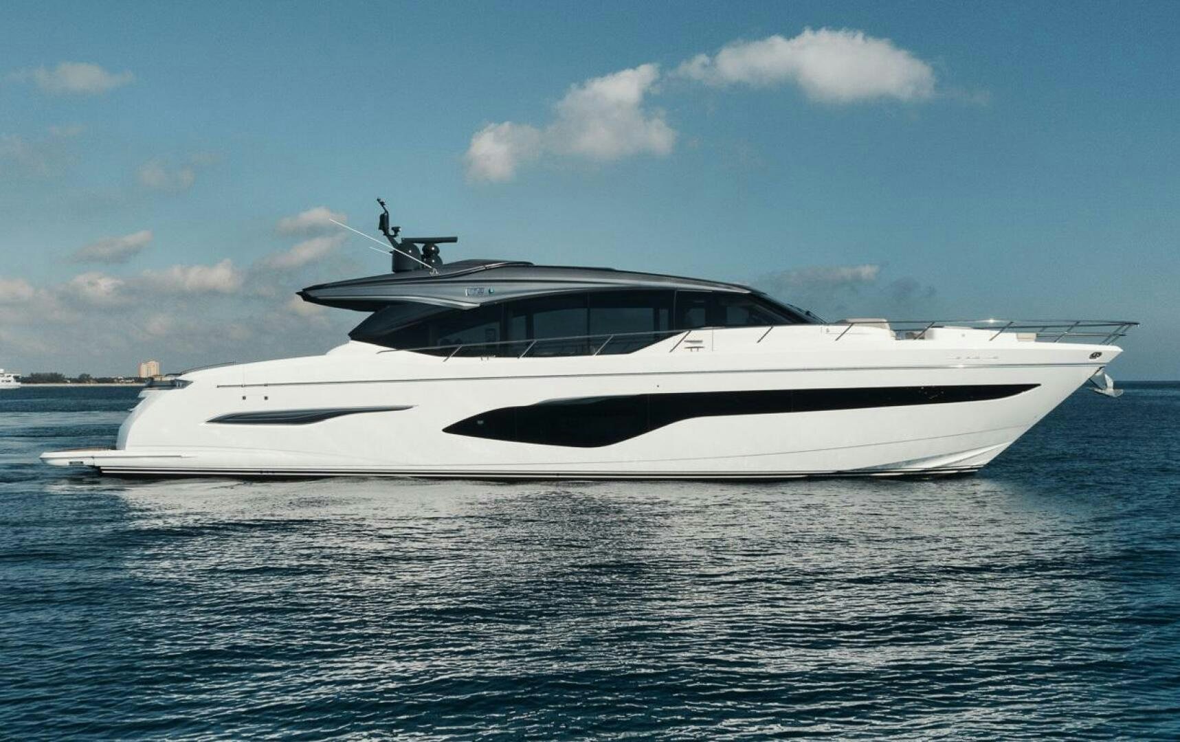 a white yacht in the water aboard HOOKED HER Yacht for Sale