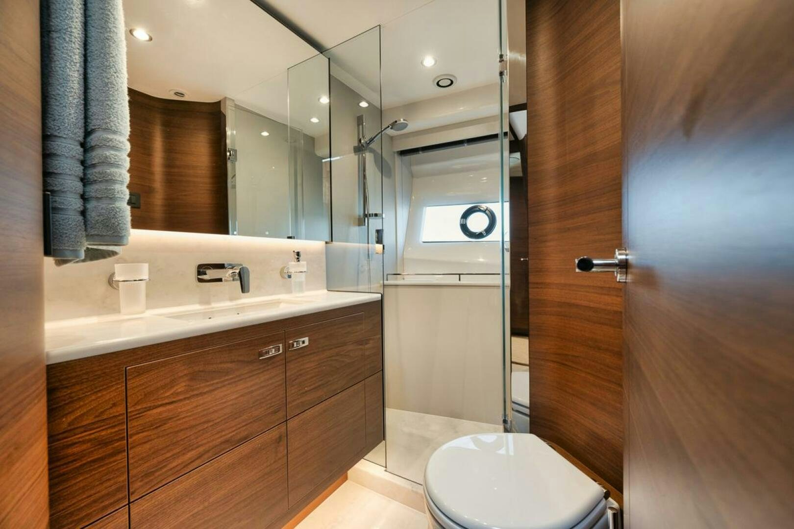 a bathroom with a glass shower aboard HOOKED HER Yacht for Sale