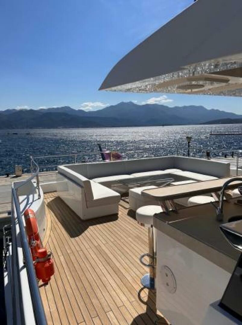 a deck with a view of a city and mountains in the background aboard PITERLAND II Yacht for Sale