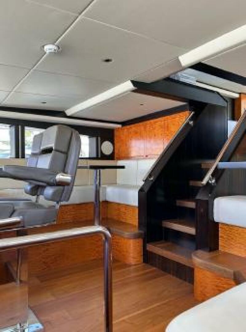 a room with a chair and a piano aboard PITERLAND II Yacht for Sale