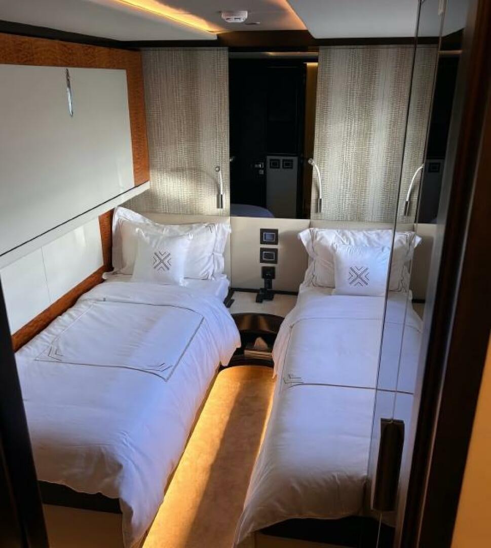 a room with beds and a window aboard PITERLAND II Yacht for Sale