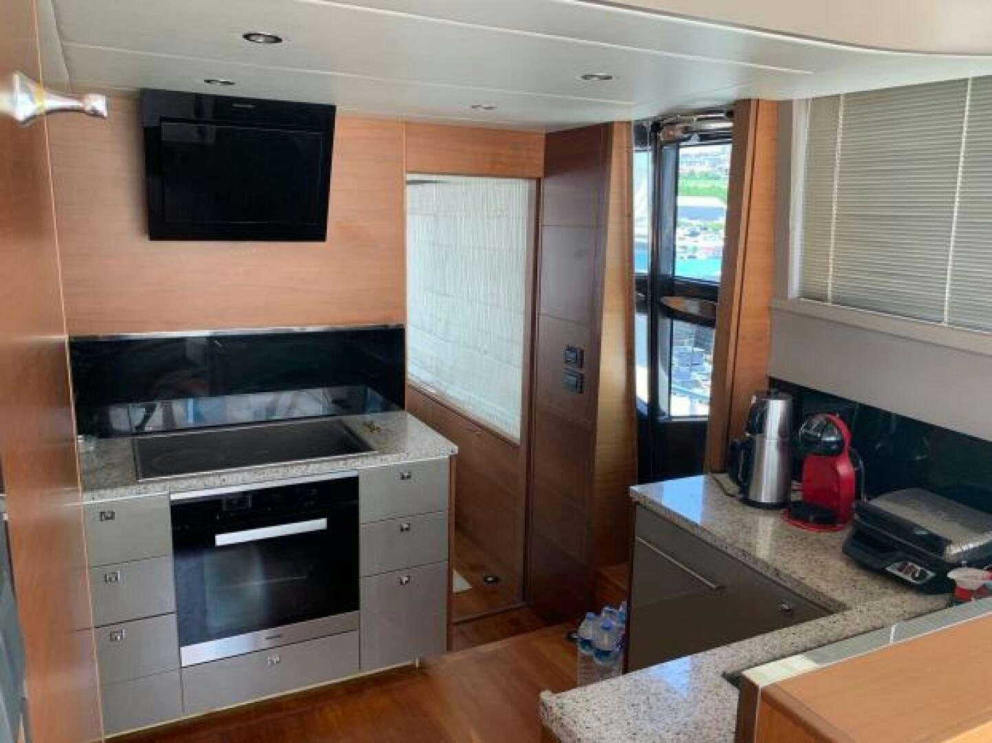 a kitchen with a stove and microwave aboard SOLDAYA Yacht for Sale
