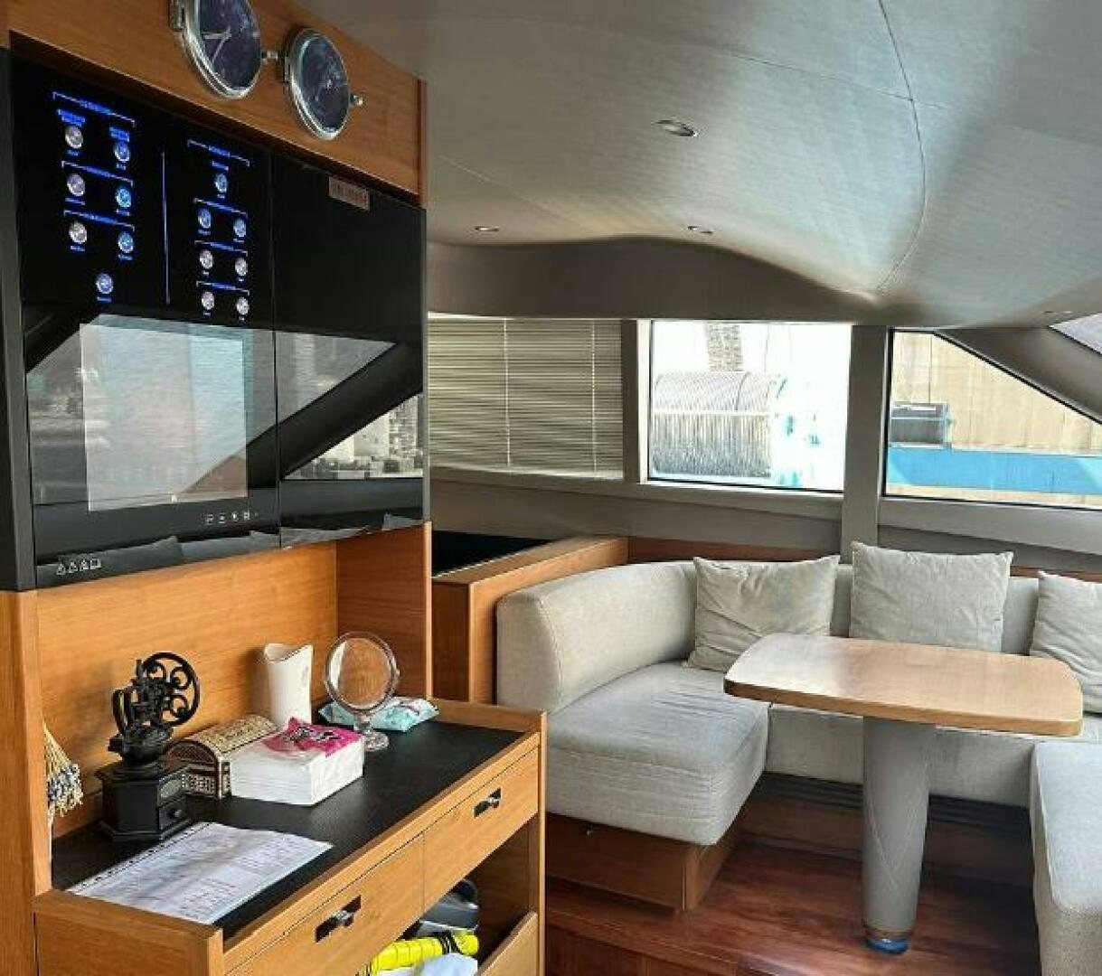 a living room with a tv and a table aboard SOLDAYA Yacht for Sale