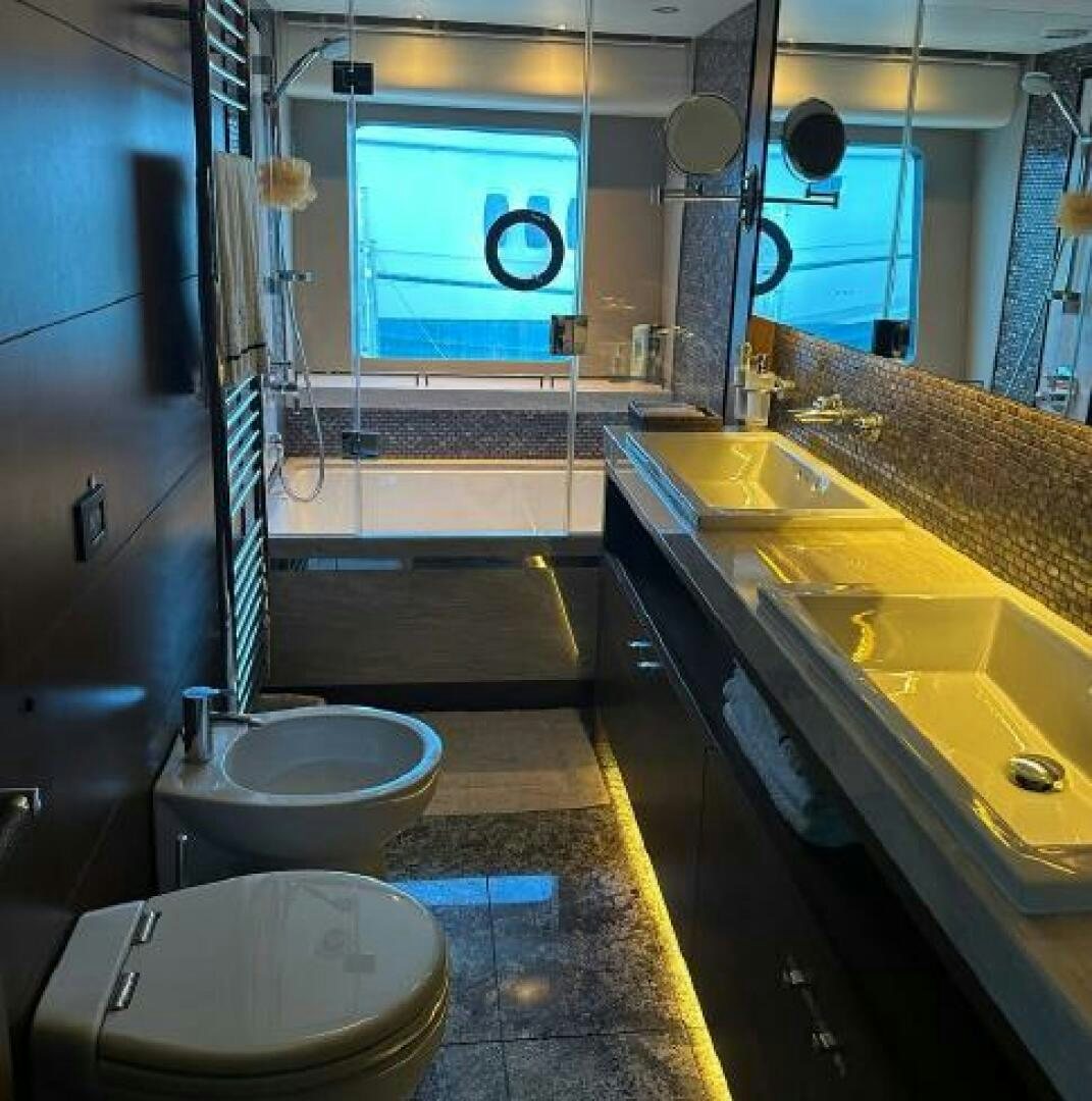 a bathroom with a toilet sink and a mirror aboard SOLDAYA Yacht for Sale