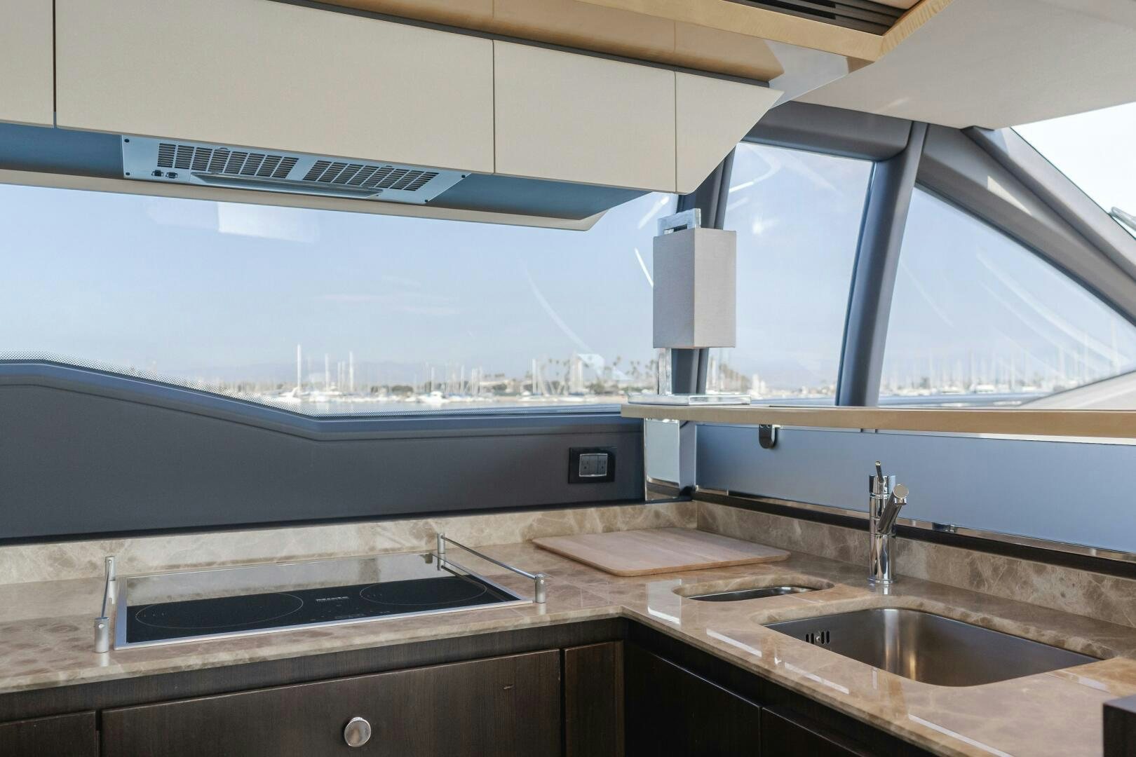 a kitchen with a sink and a large window aboard TCHANTCHES Yacht for Sale