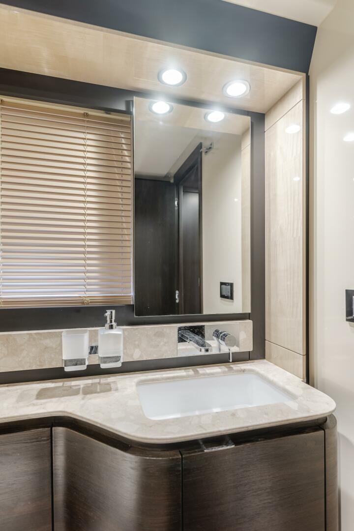a bathroom with a large mirror aboard TCHANTCHES Yacht for Sale
