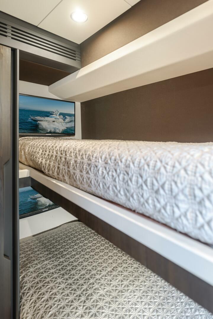 a bed with a picture on the wall aboard TCHANTCHES Yacht for Sale
