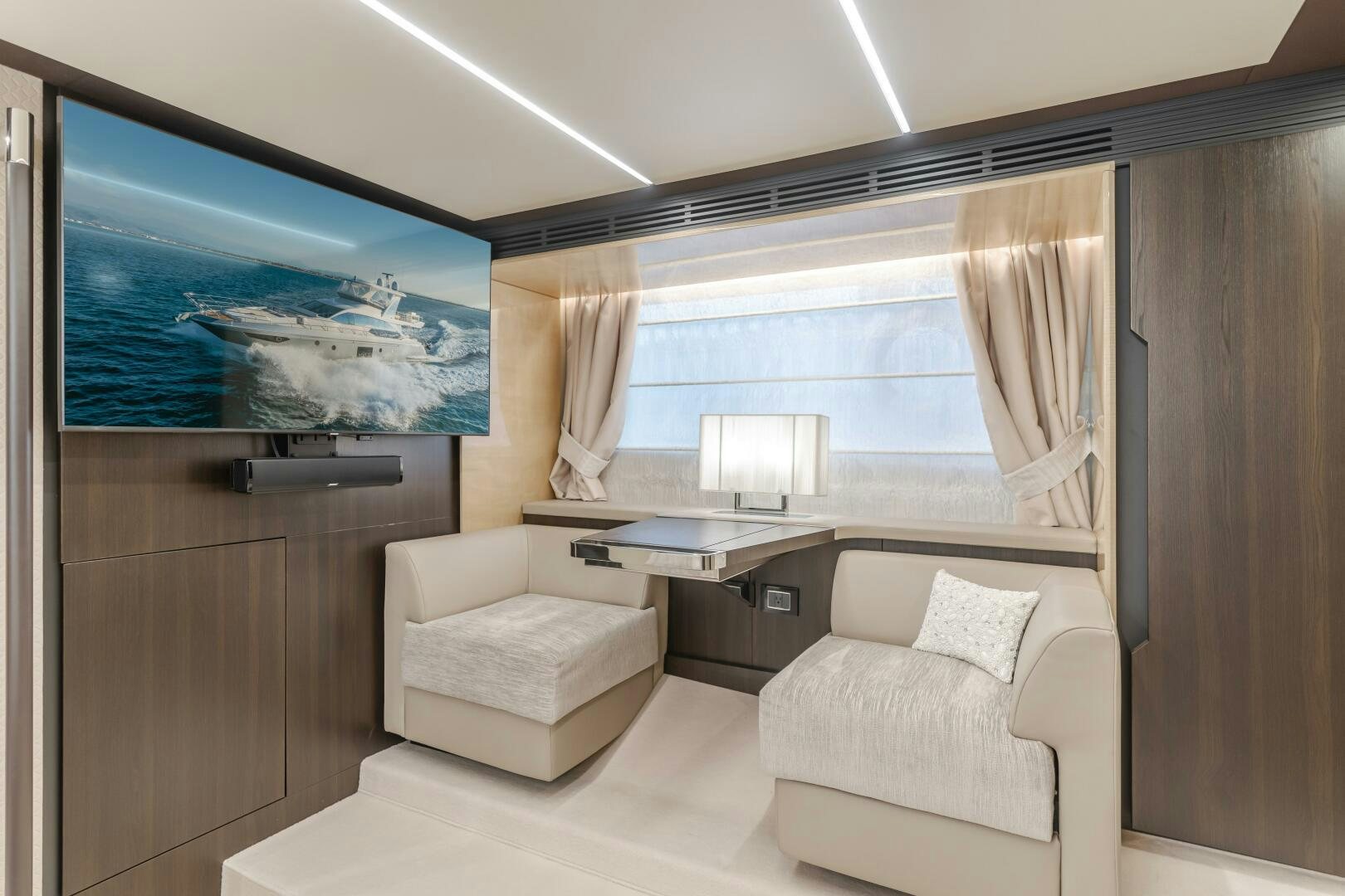 a room with a tv and a couch aboard TCHANTCHES Yacht for Sale