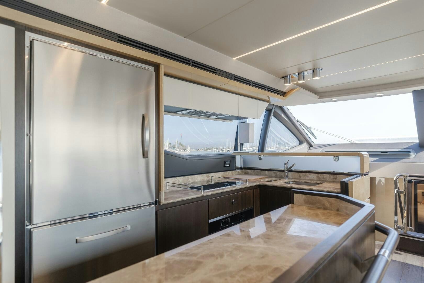 a large kitchen with a large stainless steel refrigerator aboard TCHANTCHES Yacht for Sale