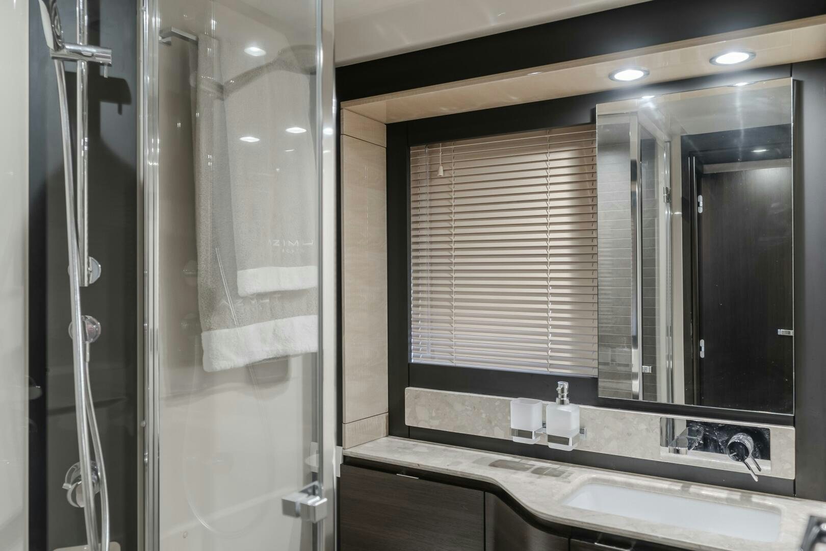 a bathroom with a shower and sink aboard TCHANTCHES Yacht for Sale