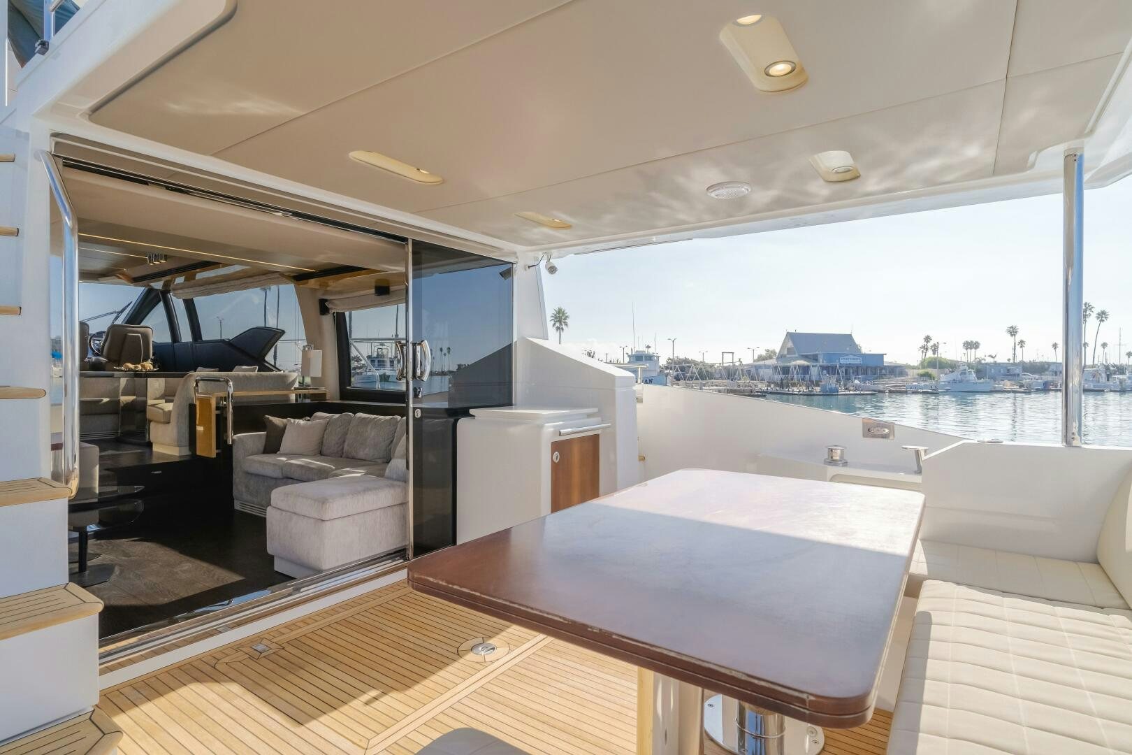 a room with a table and couches aboard TCHANTCHES Yacht for Sale