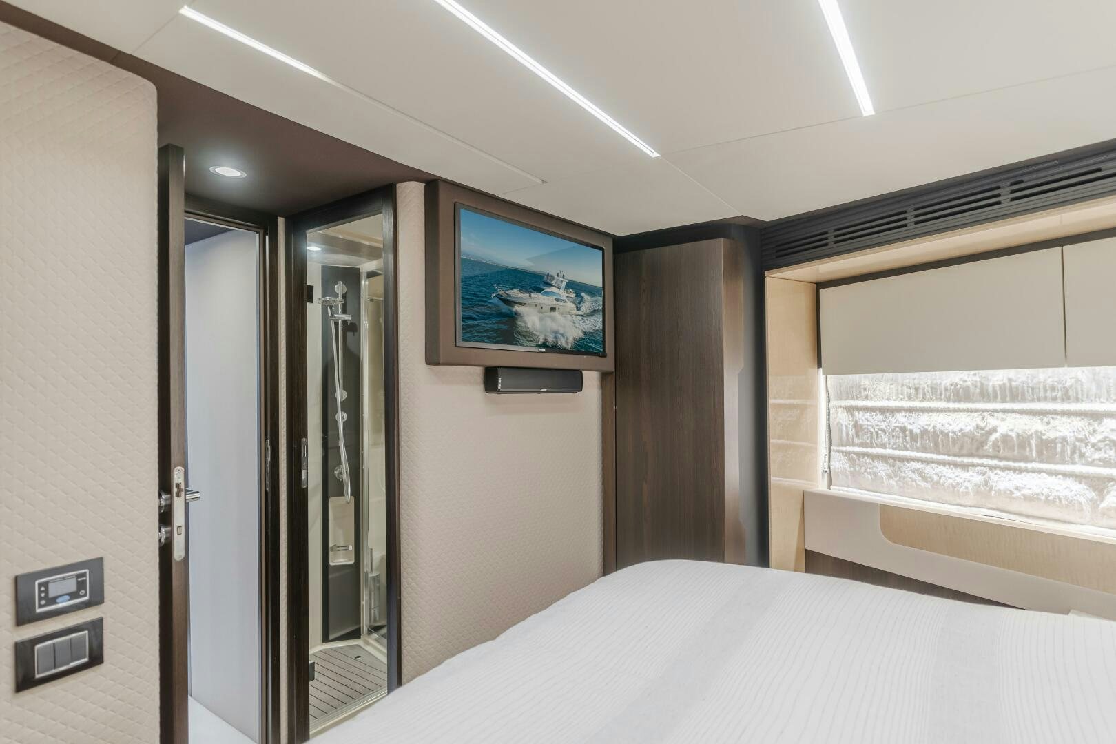 a hotel room with a tv on the wall aboard TCHANTCHES Yacht for Sale