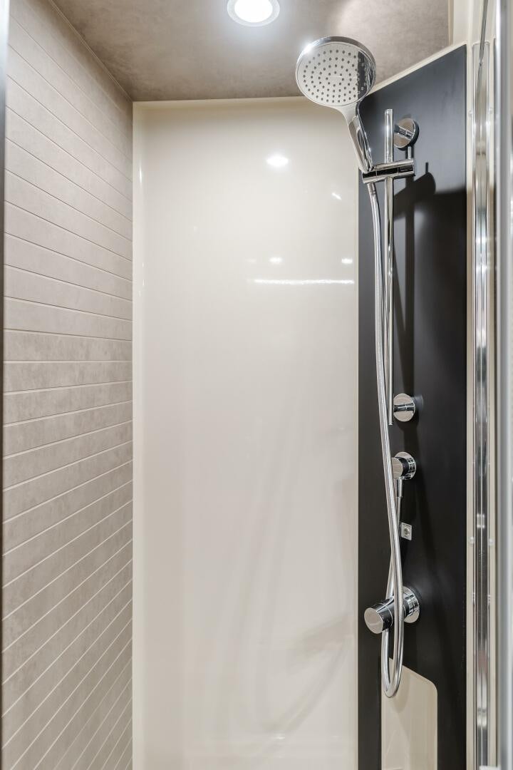 a shower with a light on the wall aboard TCHANTCHES Yacht for Sale