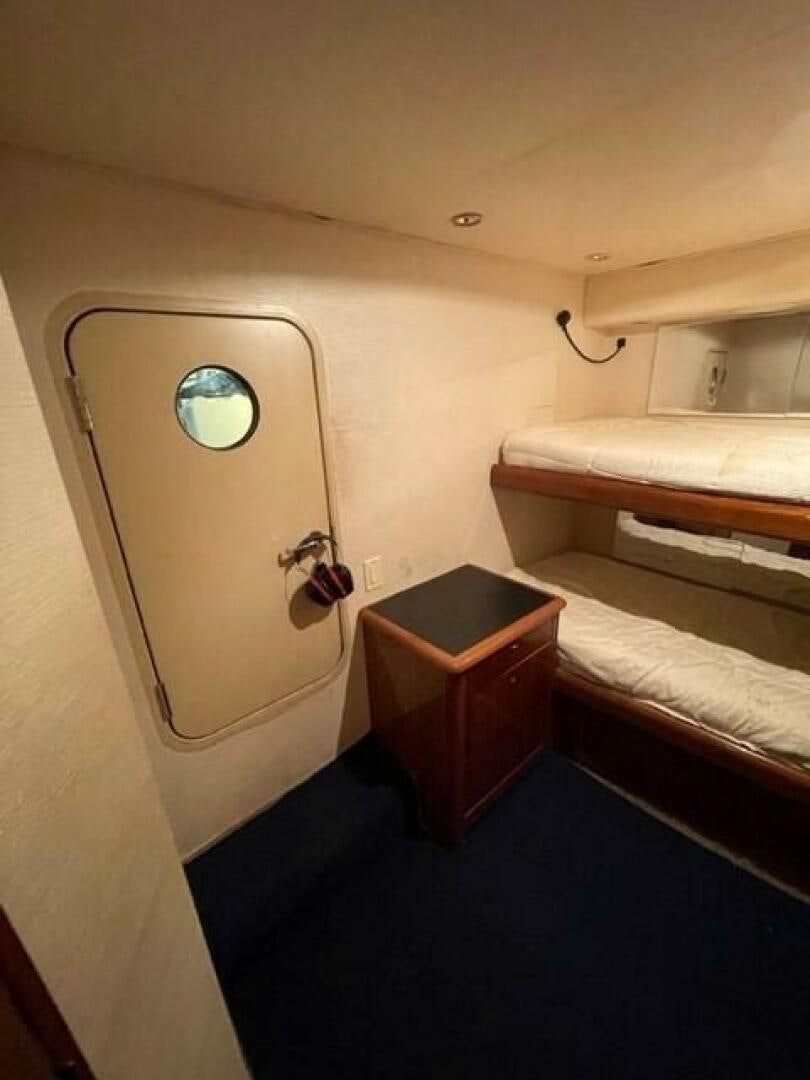 a room with a bed and a mirror aboard 6 C Yacht for Sale