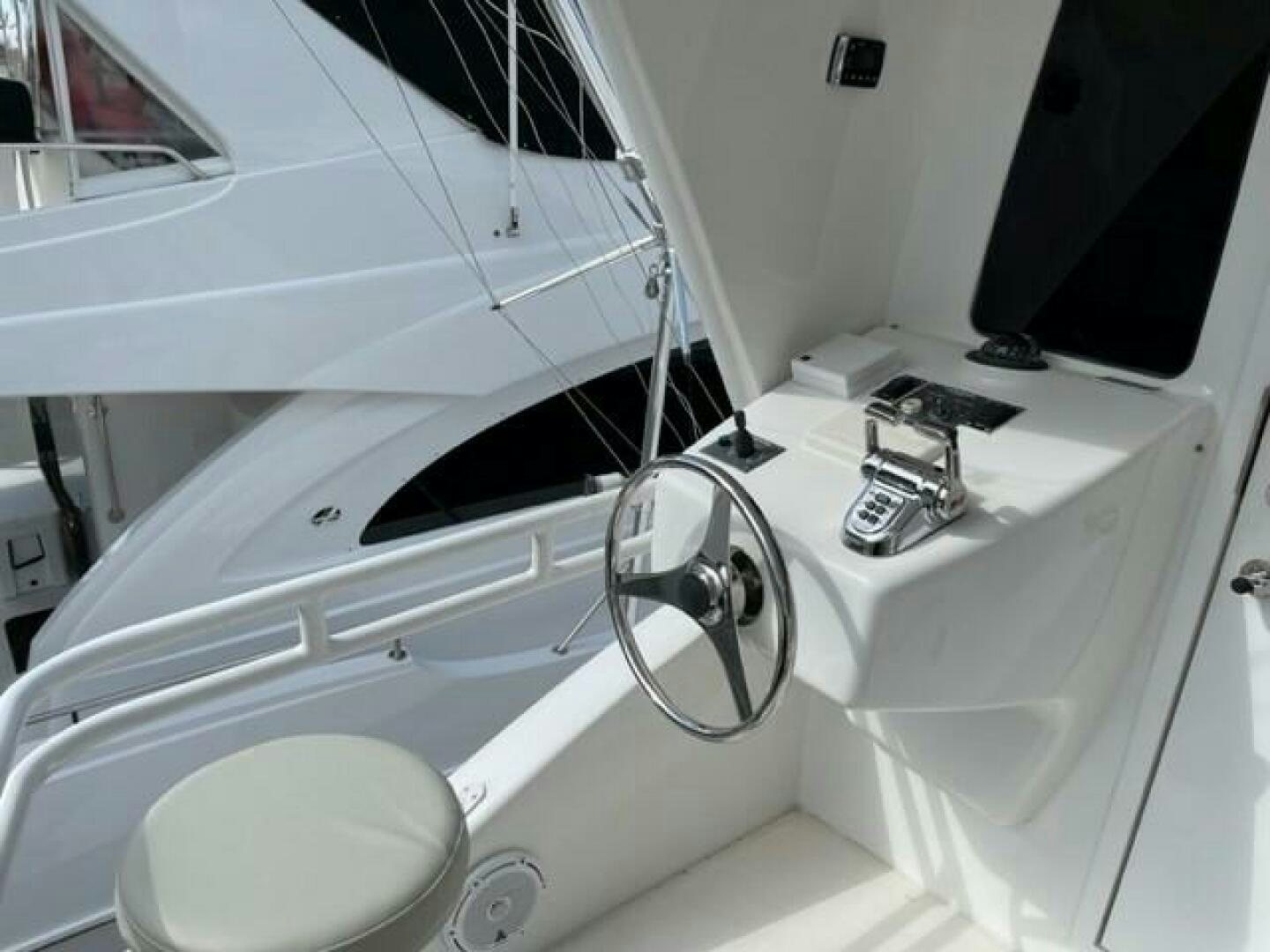 a white bathtub with a sink and faucet aboard 6 C Yacht for Sale