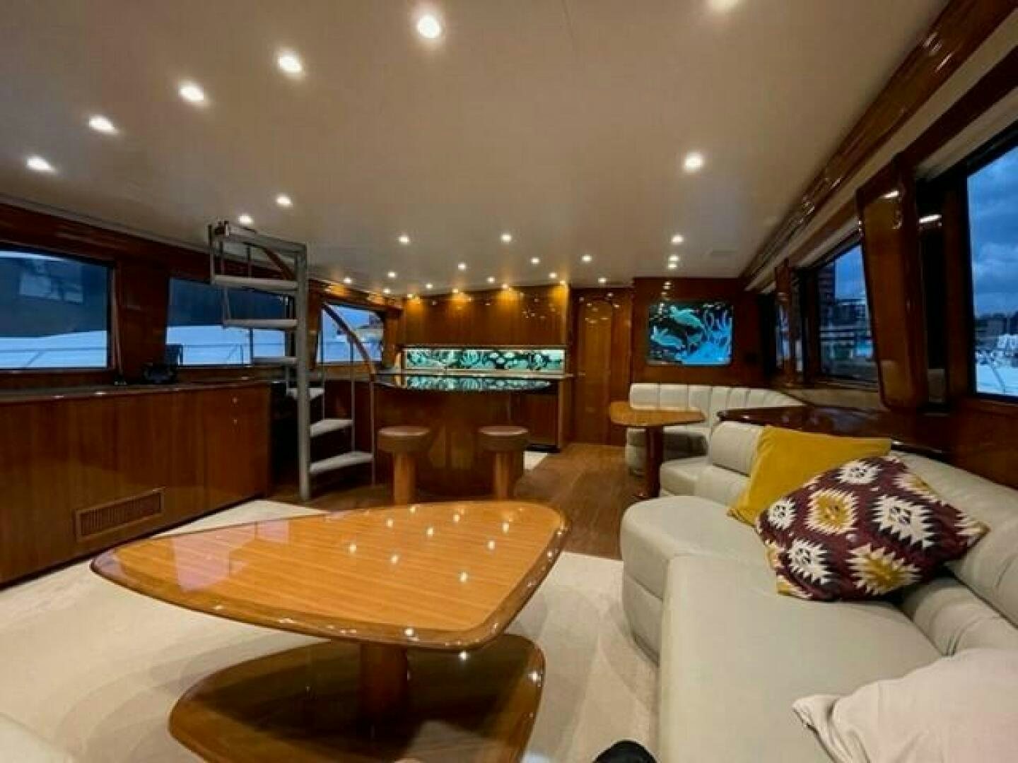 a living room with a table and couches aboard 6 C Yacht for Sale