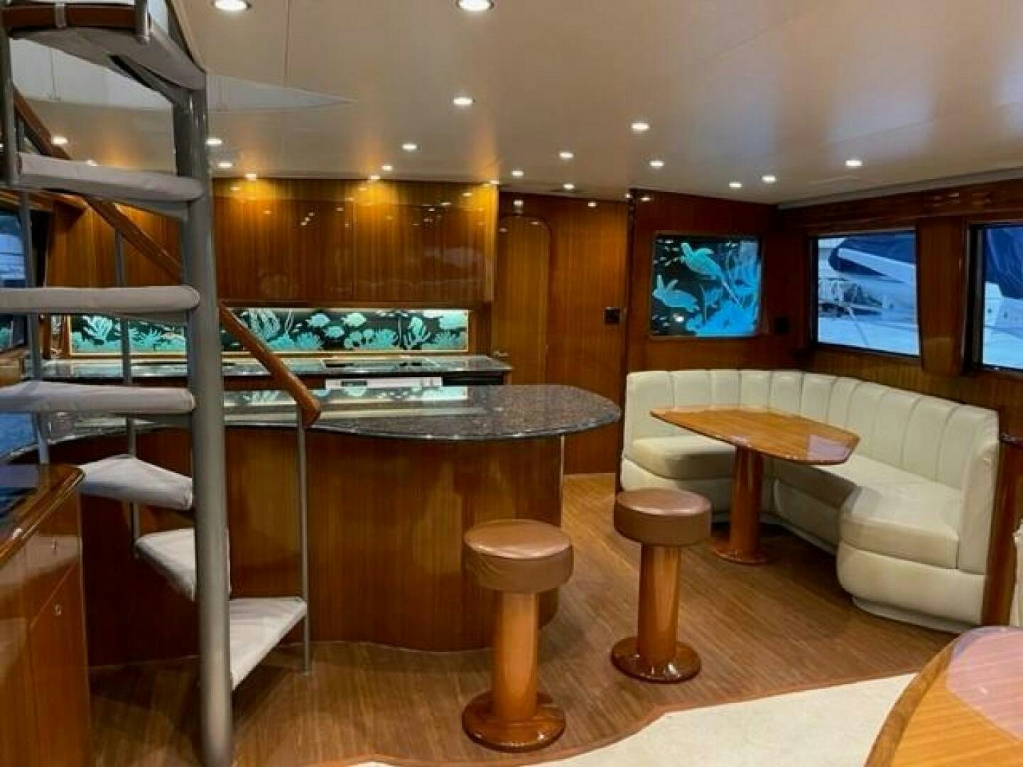 a room with a table and chairs aboard 6 C Yacht for Sale