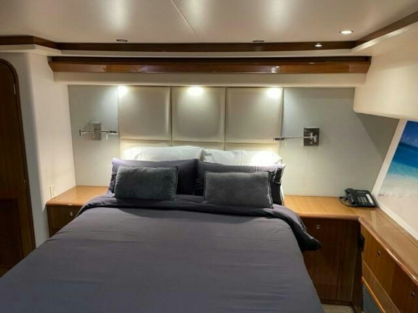 a bed with a black and white bed spread aboard 6 C Yacht for Sale