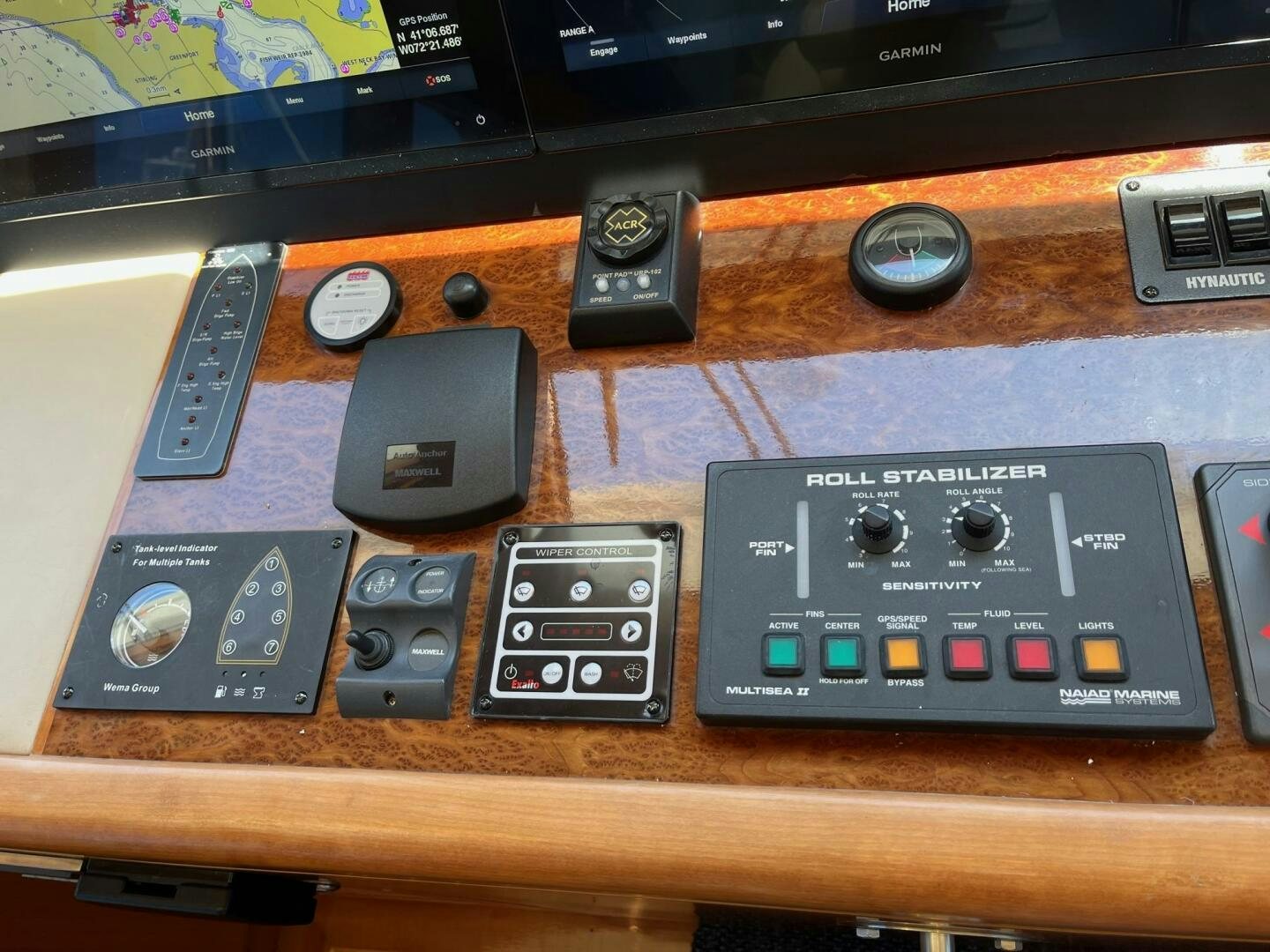 a group of remote controls on a table aboard SIG:PRN Yacht for Sale