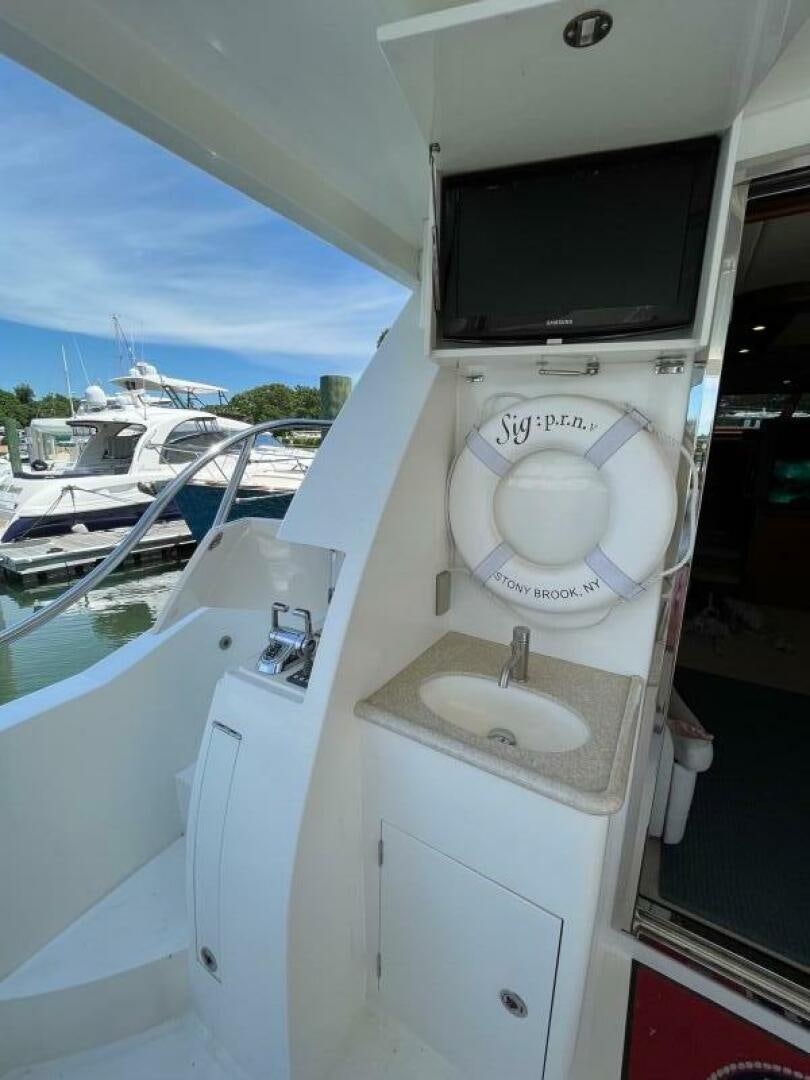 a white machine with a sink and a television on it aboard SIG:PRN Yacht for Sale