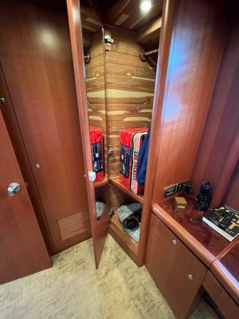 a closet with clothes and clothes aboard SIG:PRN Yacht for Sale