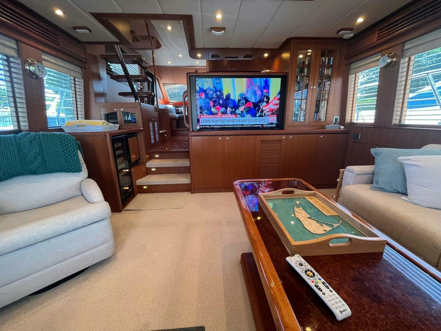 a living room with a tv and couches aboard SIG:PRN Yacht for Sale