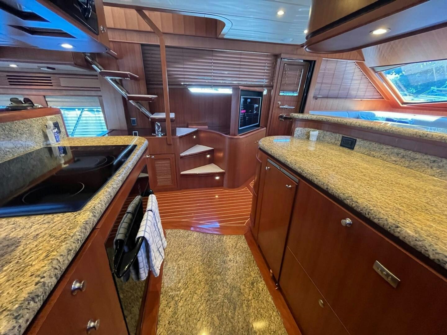 a kitchen with wooden cabinets aboard SIG:PRN Yacht for Sale