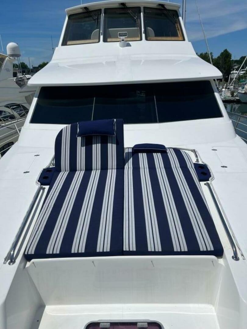 a white and blue striped boat aboard SIG:PRN Yacht for Sale
