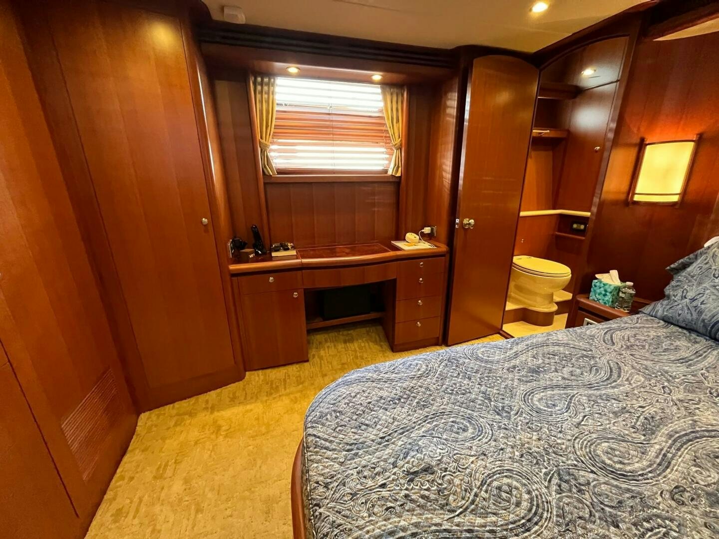 a bedroom with a bed and desk aboard SIG:PRN Yacht for Sale