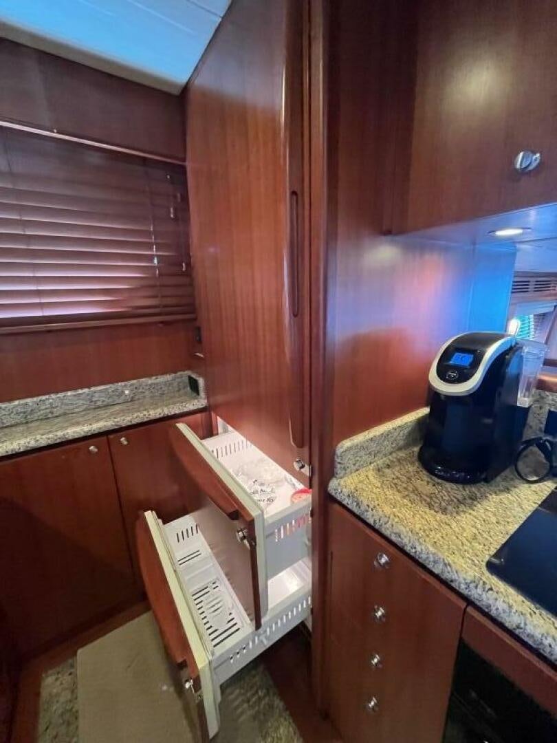 a wooden cabinet with a white box and a blue object on it aboard SIG:PRN Yacht for Sale