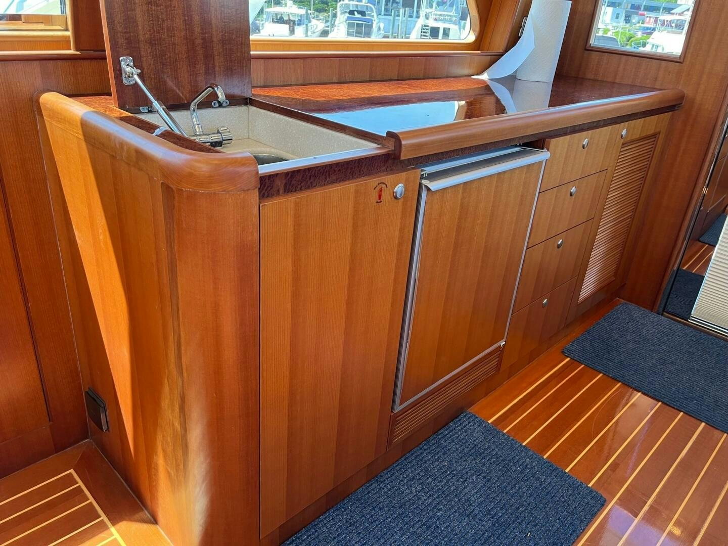 a kitchen with wooden cabinets aboard SIG:PRN Yacht for Sale