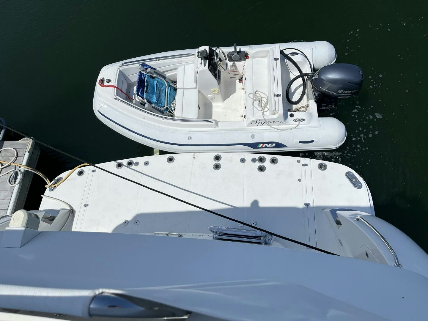 a white boat with a blue stripe aboard SIG:PRN Yacht for Sale