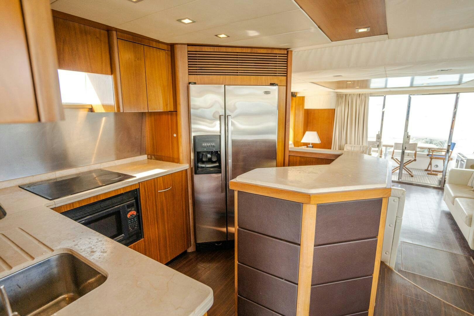 a kitchen with a stainless steel refrigerator aboard BAR&CO Yacht for Sale
