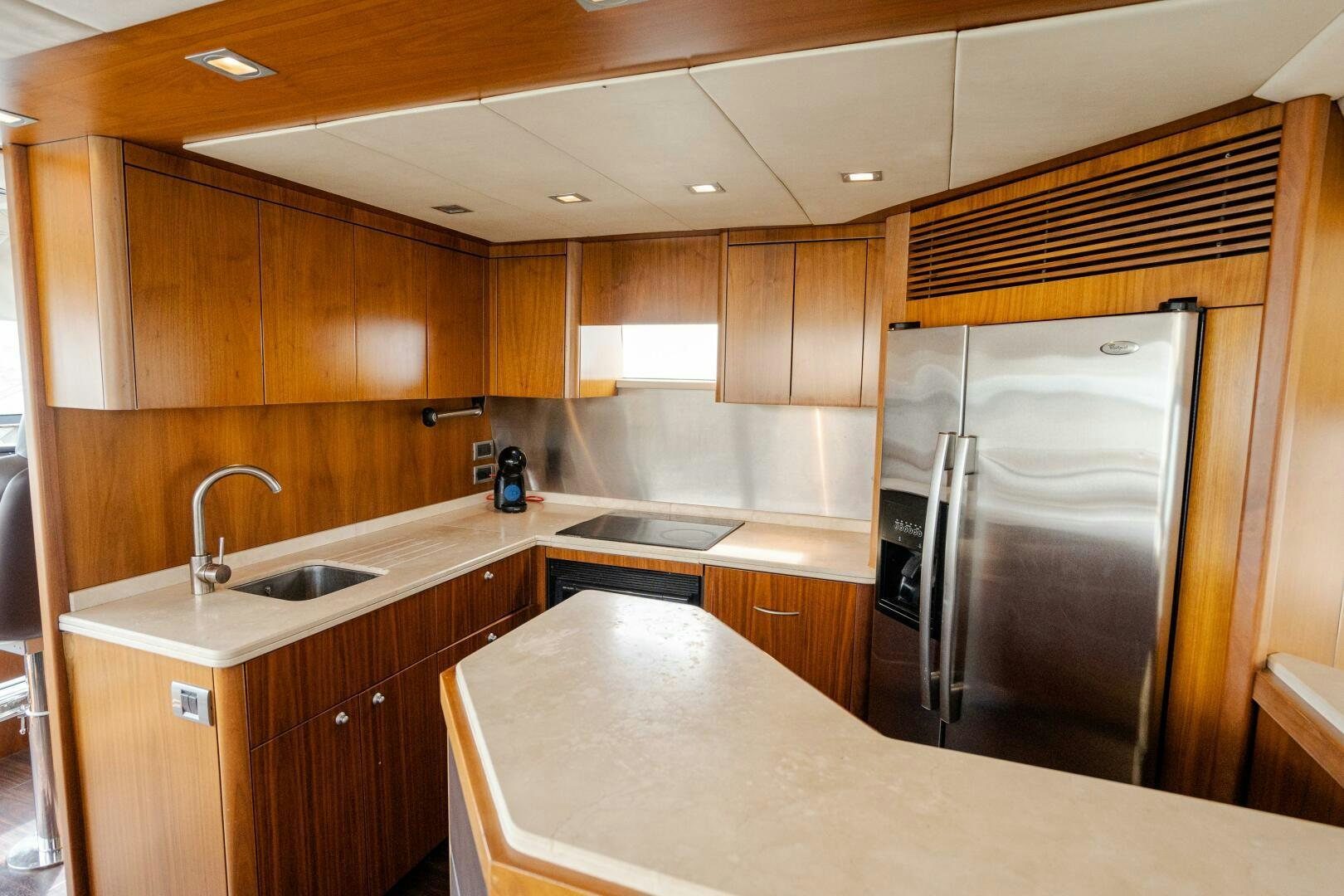 a kitchen with a stainless steel refrigerator aboard BAR&CO Yacht for Sale