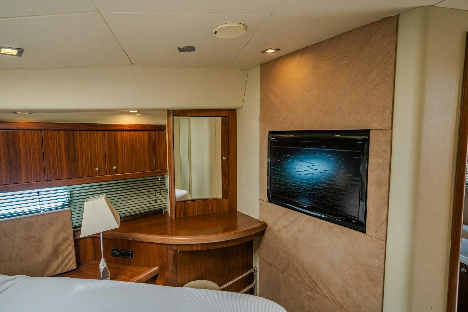 a living room with a tv aboard BAR&CO Yacht for Sale