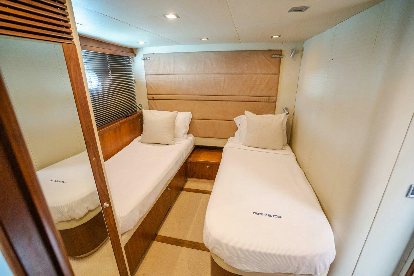 a room with a bed and a mirror aboard BAR&CO Yacht for Sale