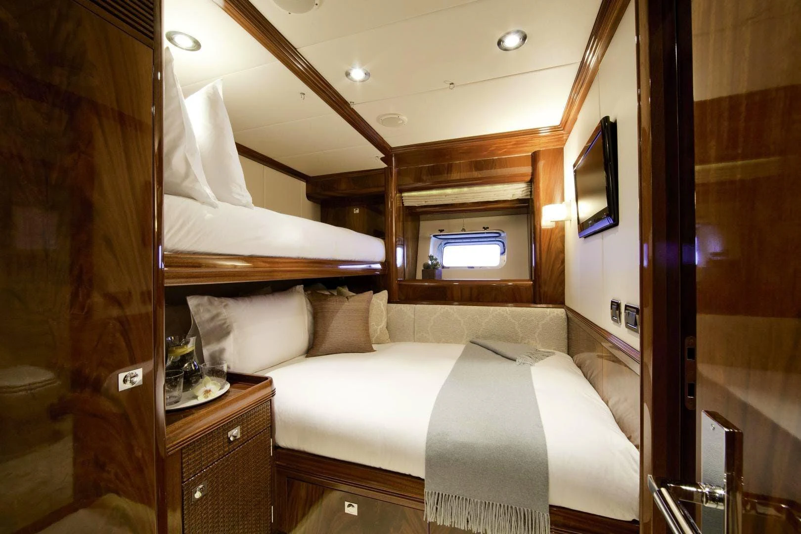 a room with a bed and a television aboard DESTINATION Yacht for Sale