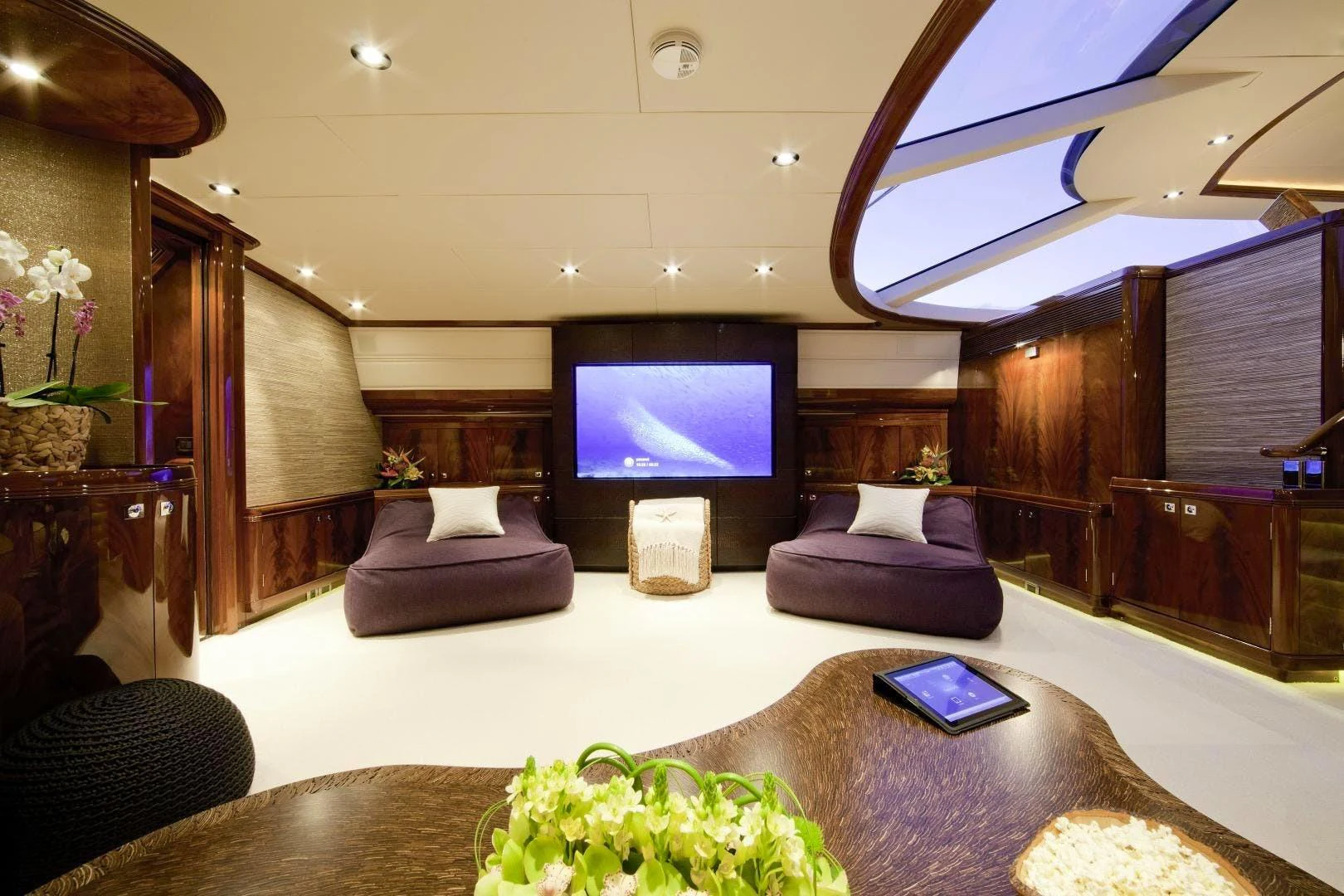 a living room with a tv and a couch aboard DESTINATION Yacht for Sale