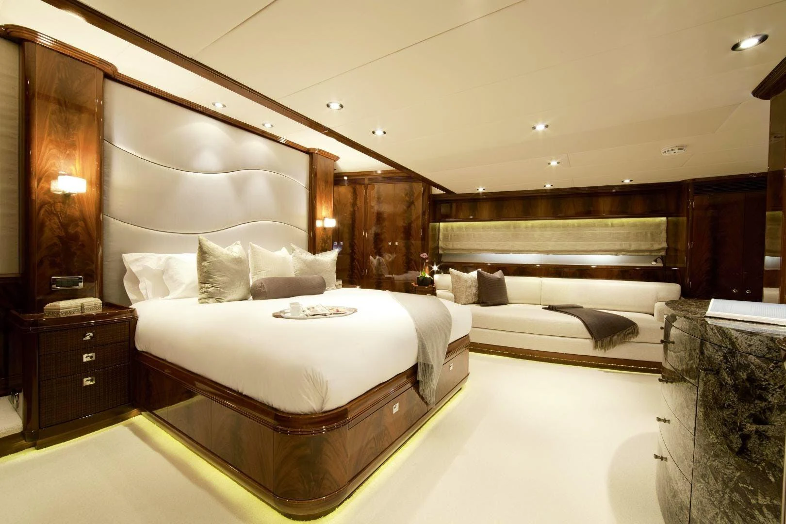 a room with a bed and a couch aboard DESTINATION Yacht for Sale
