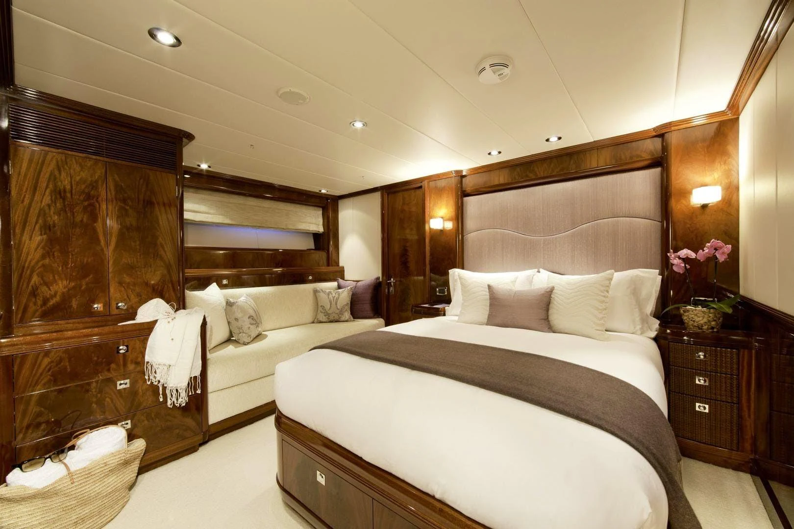 a bedroom with a bed and a couch aboard DESTINATION Yacht for Sale