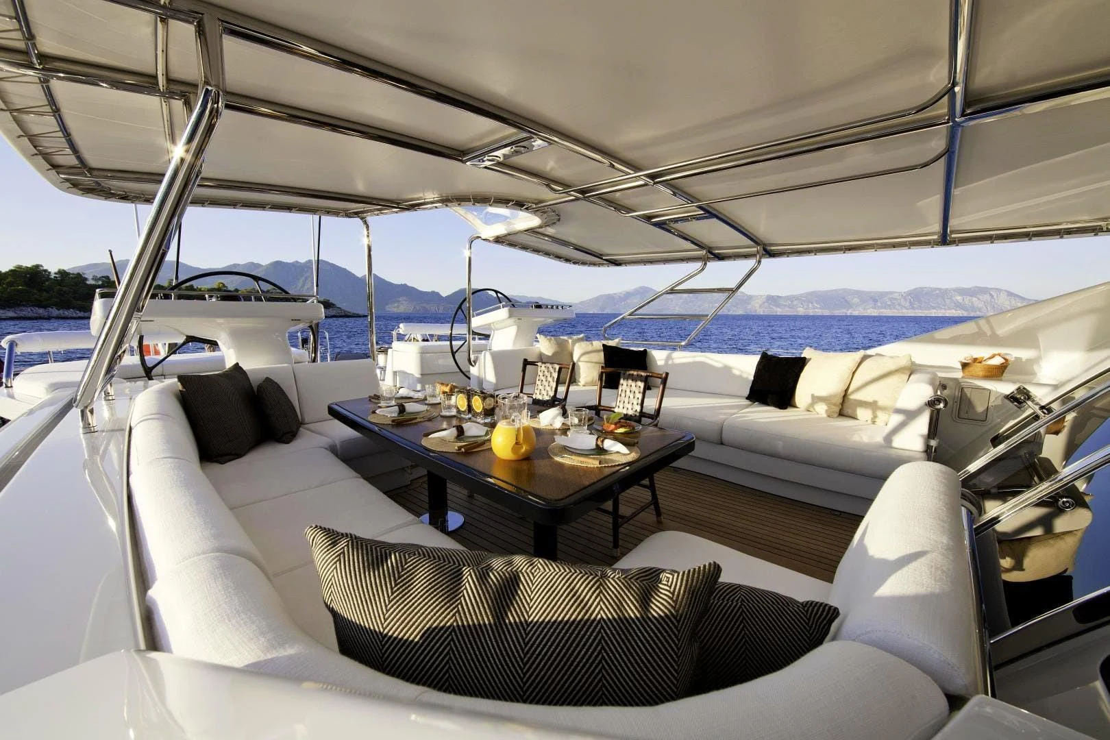 a boat with a table and chairs aboard DESTINATION Yacht for Sale