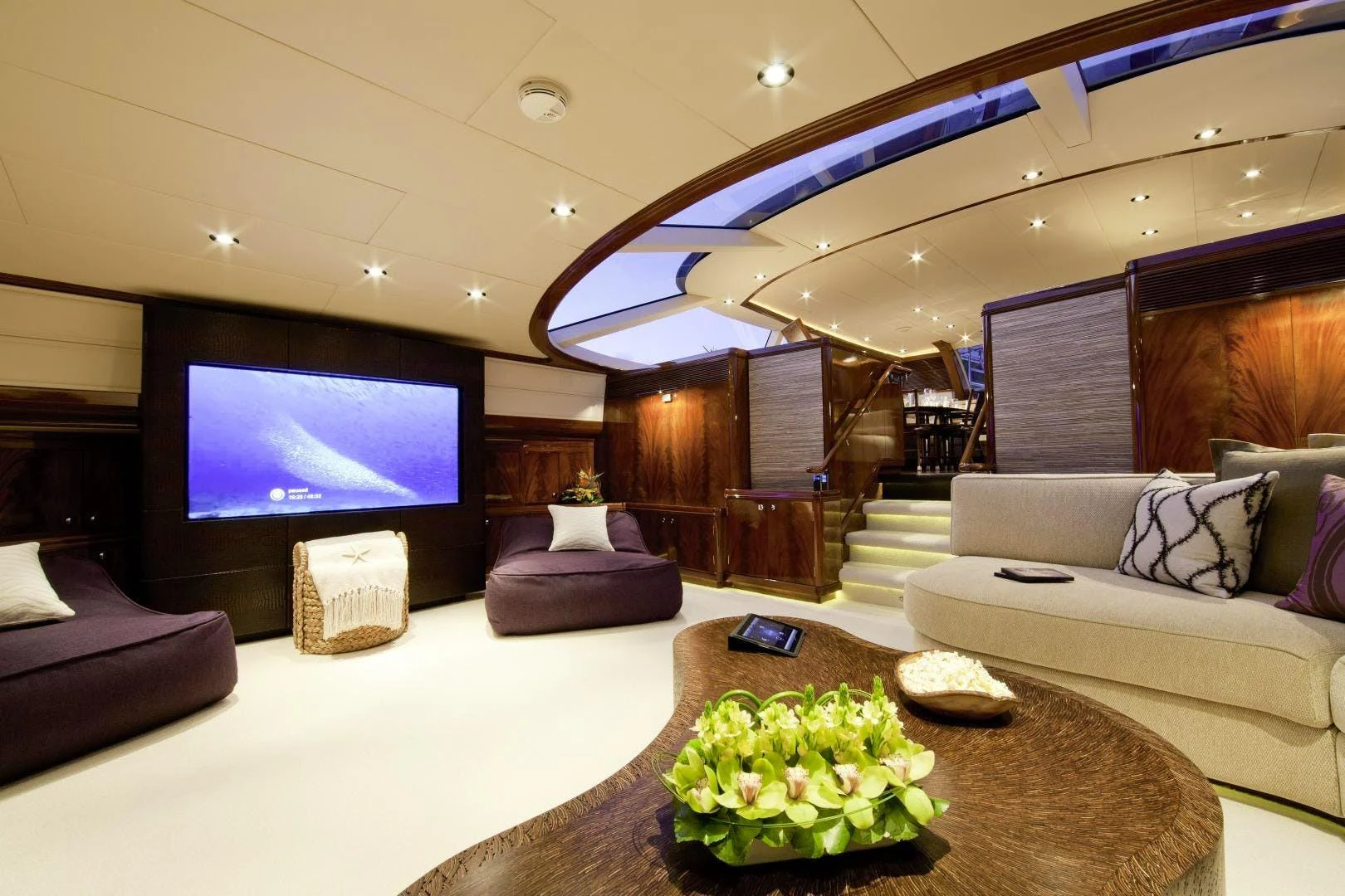 a living room with a large screen aboard DESTINATION Yacht for Sale