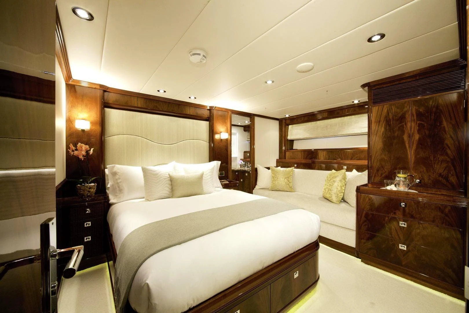 a bedroom with a bed and a dresser aboard DESTINATION Yacht for Sale
