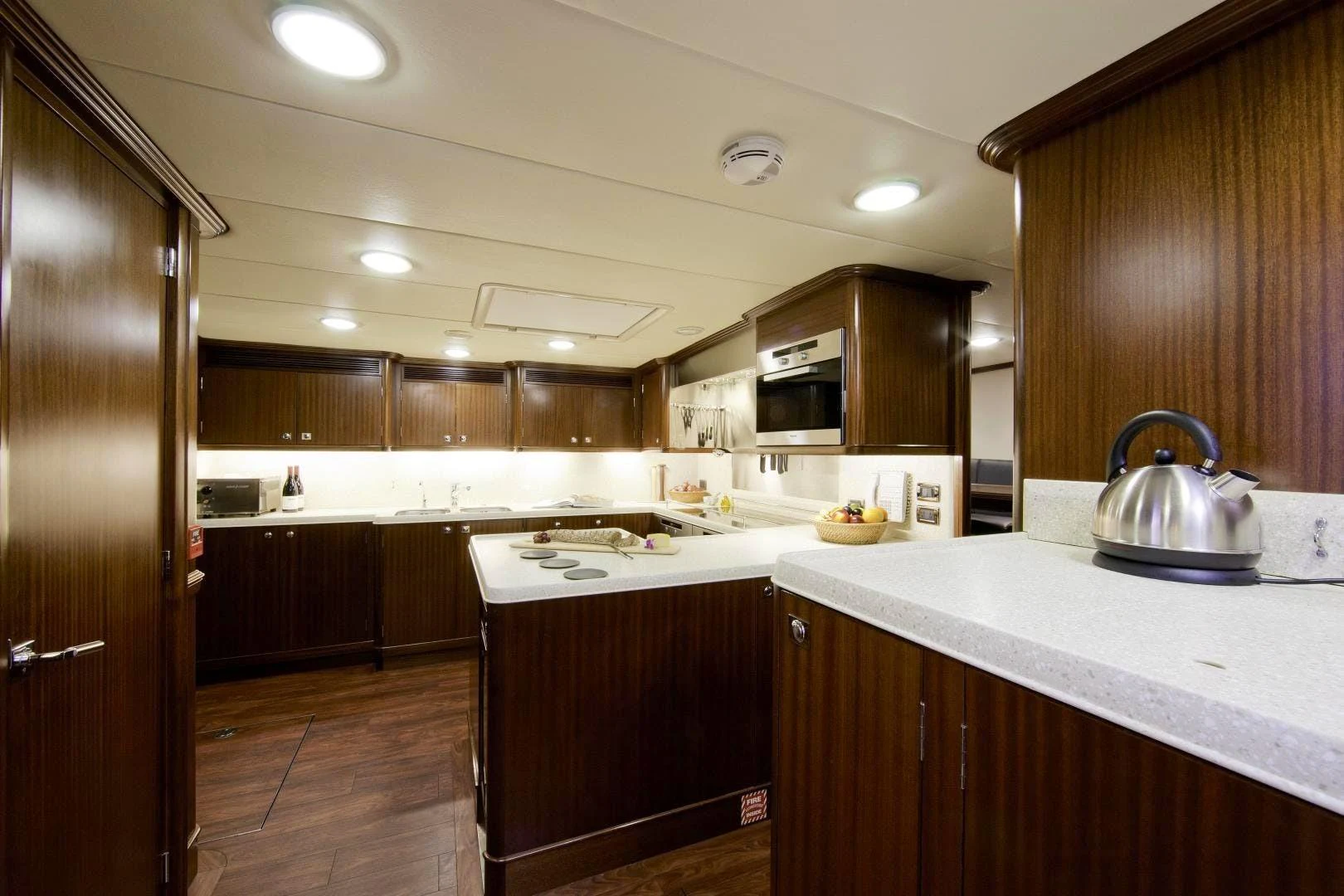 a kitchen with wooden cabinets aboard DESTINATION Yacht for Sale