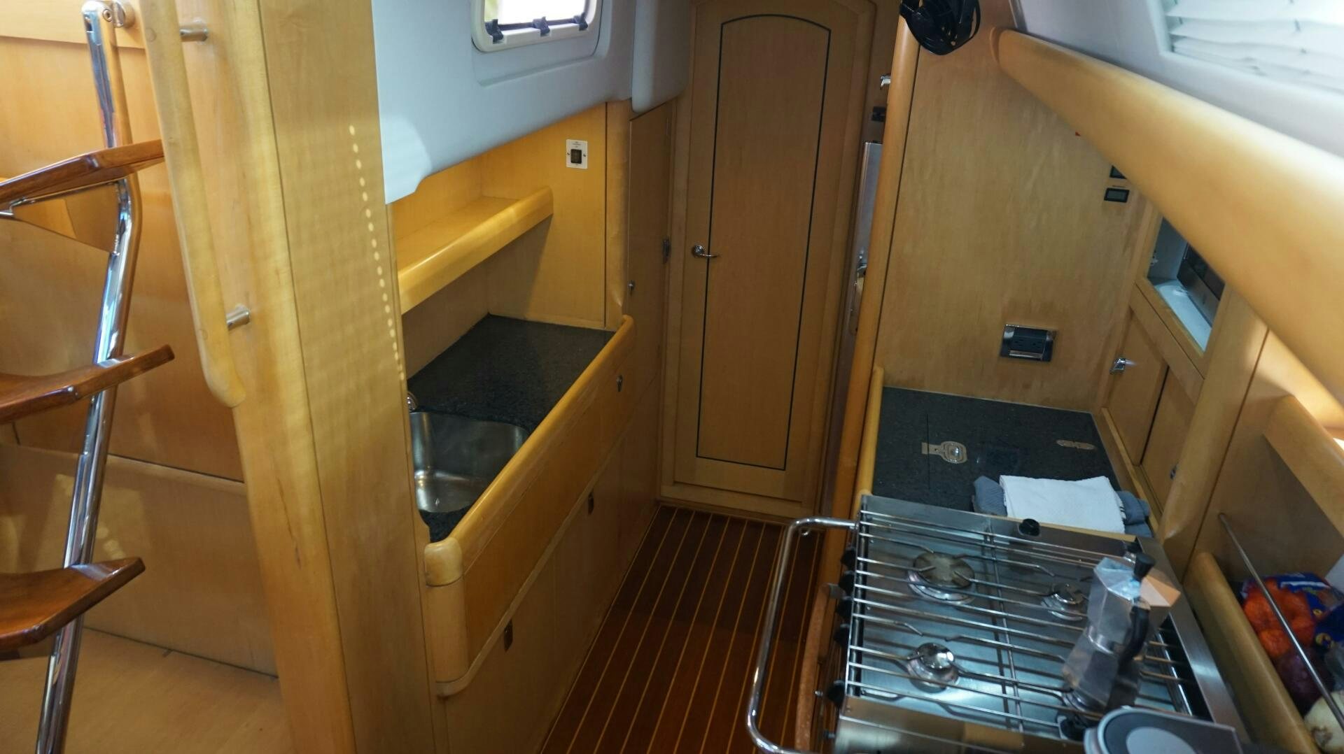 a kitchen with wooden cabinets aboard DOLCE VITA Yacht for Sale