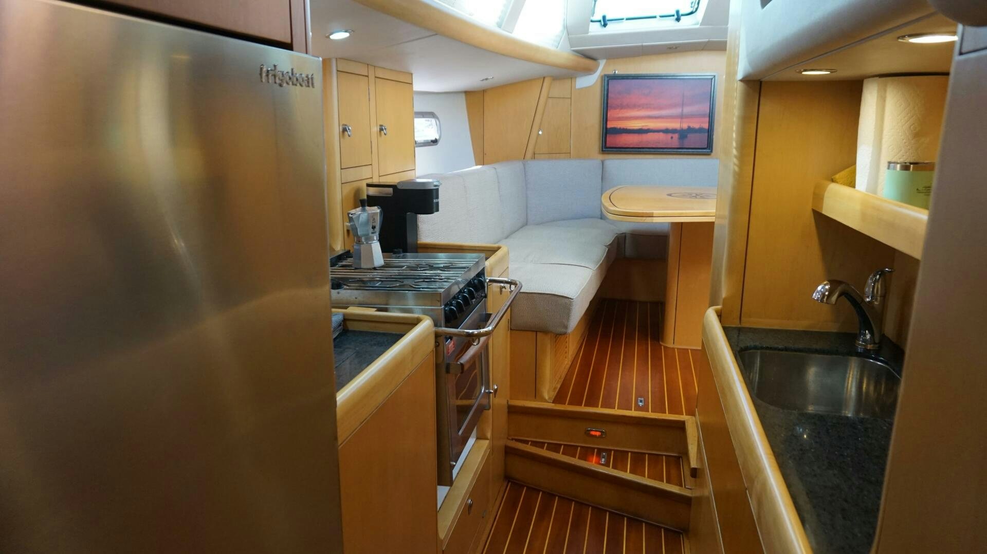 a kitchen with a sink and a couch aboard DOLCE VITA Yacht for Sale