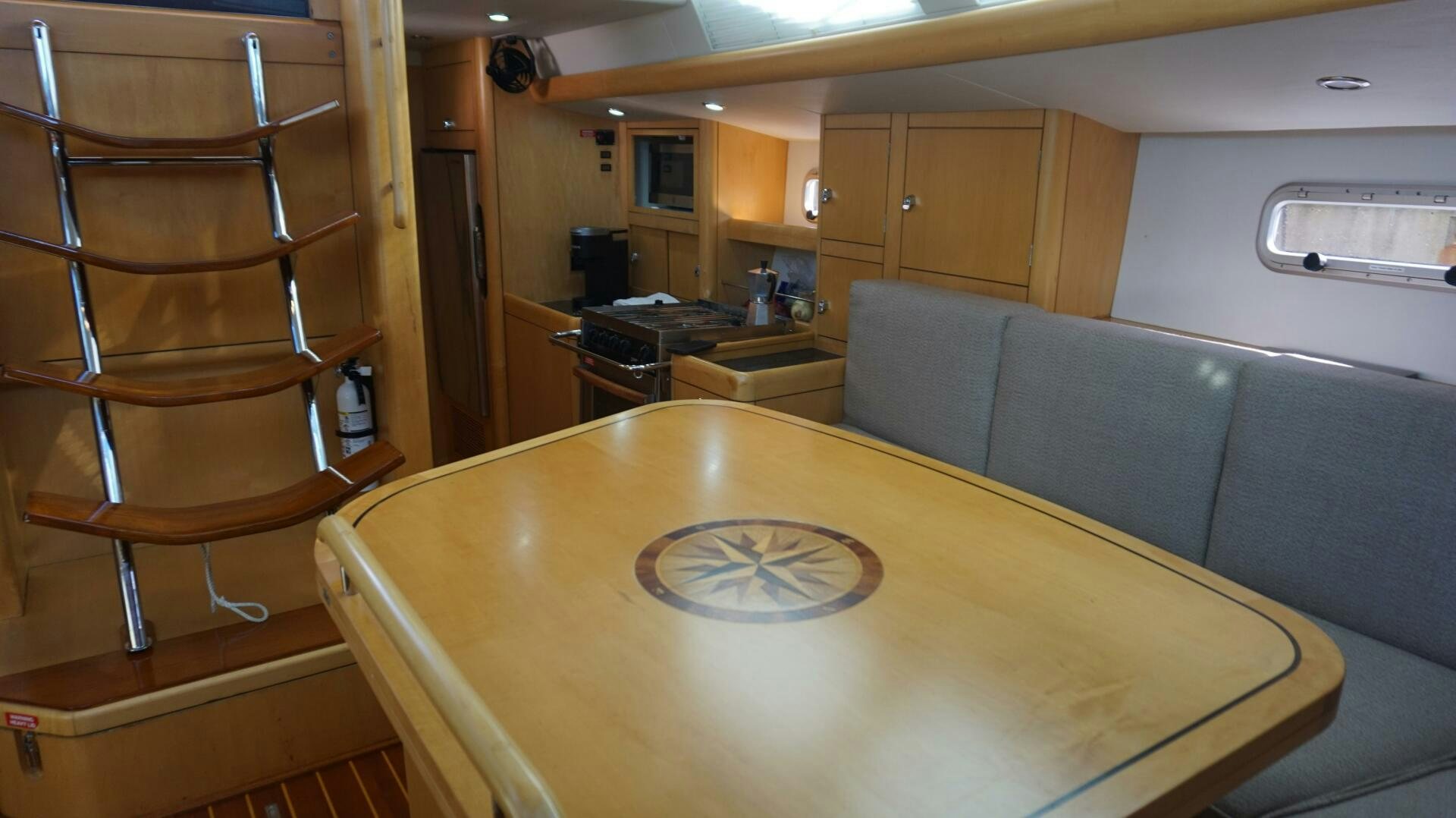 a room with a table and chairs aboard DOLCE VITA Yacht for Sale