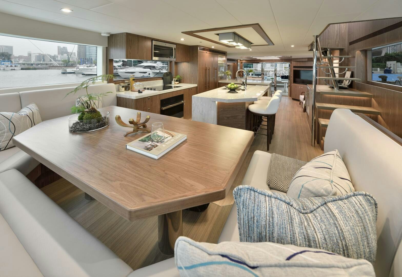a living room with a table and couches aboard V77S 610 Yacht for Sale