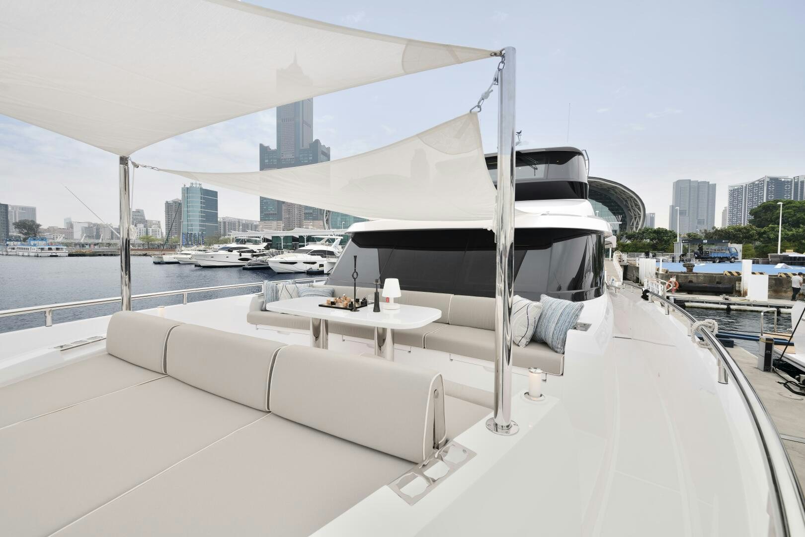 a white lounge chair on a balcony aboard V77S 610 Yacht for Sale